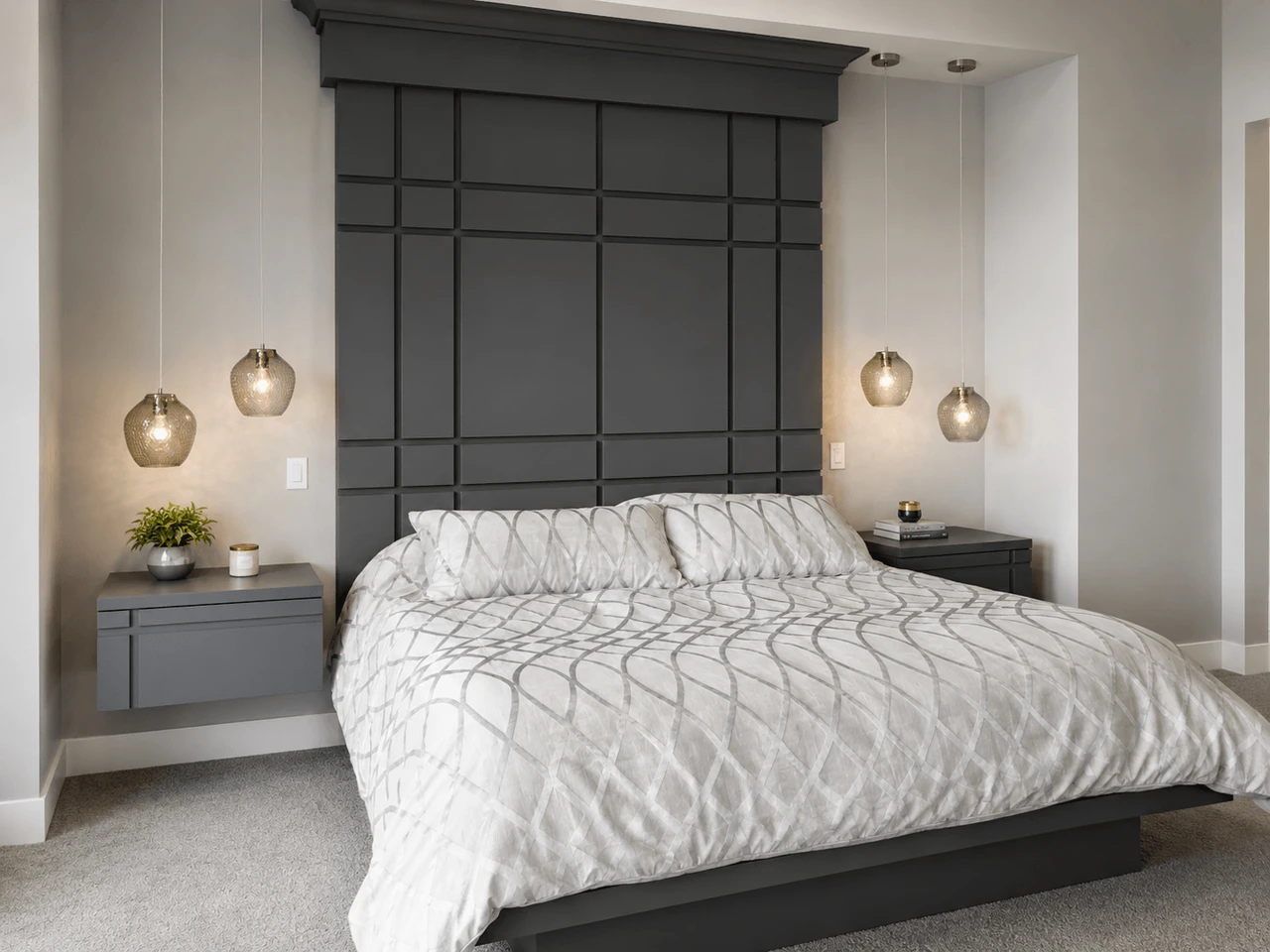 Stellar Craft Cabinetry Inc. custom modern dark wood cabinetry and built-in wall panel in a bedroom
