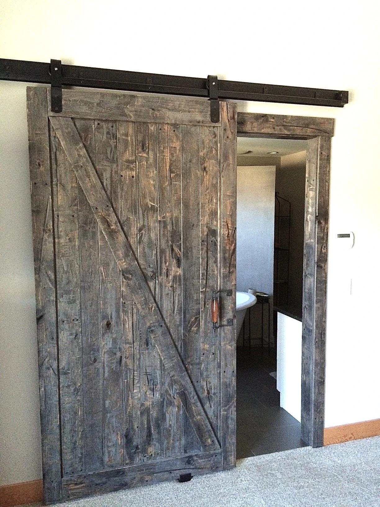 Stellar Craft Cabinetry Inc. rustic barn-style cabinet door installation