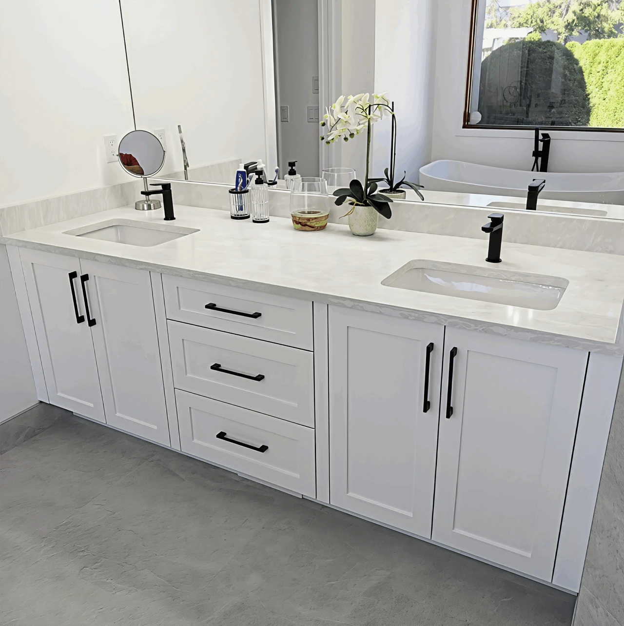 Stellar Craft Cabinetry Inc. white bathroom vanity with double sinks and modern faucets