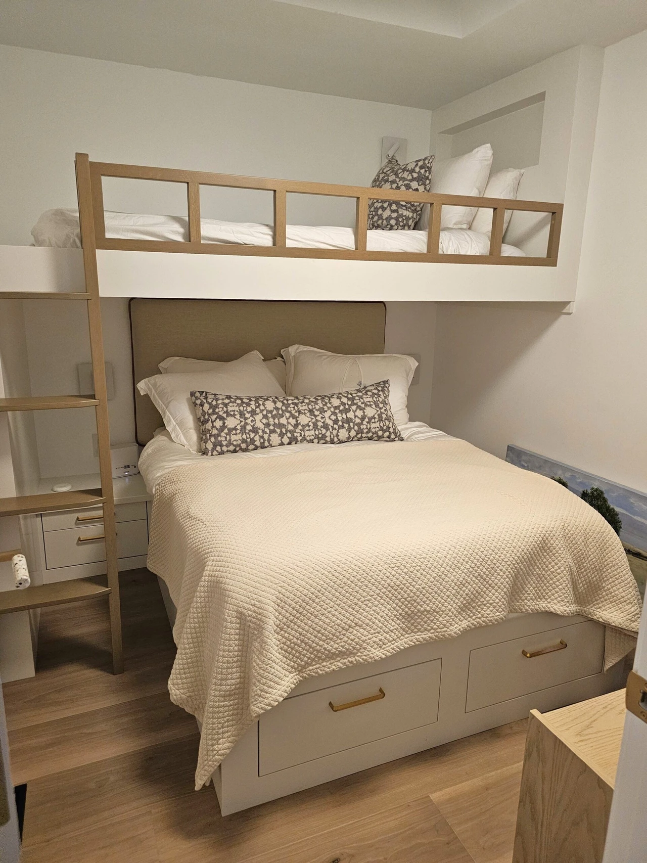 Custom built-in cabinetry and shelving with a stylish bed setup in a bedroom by Stellar Craft Cabinetry Inc.