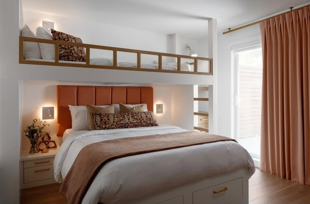 Stellar Craft Cabinetry Inc. custom built-in shelving and storage bedroom cabinetry with warm wood accents and window treatments
