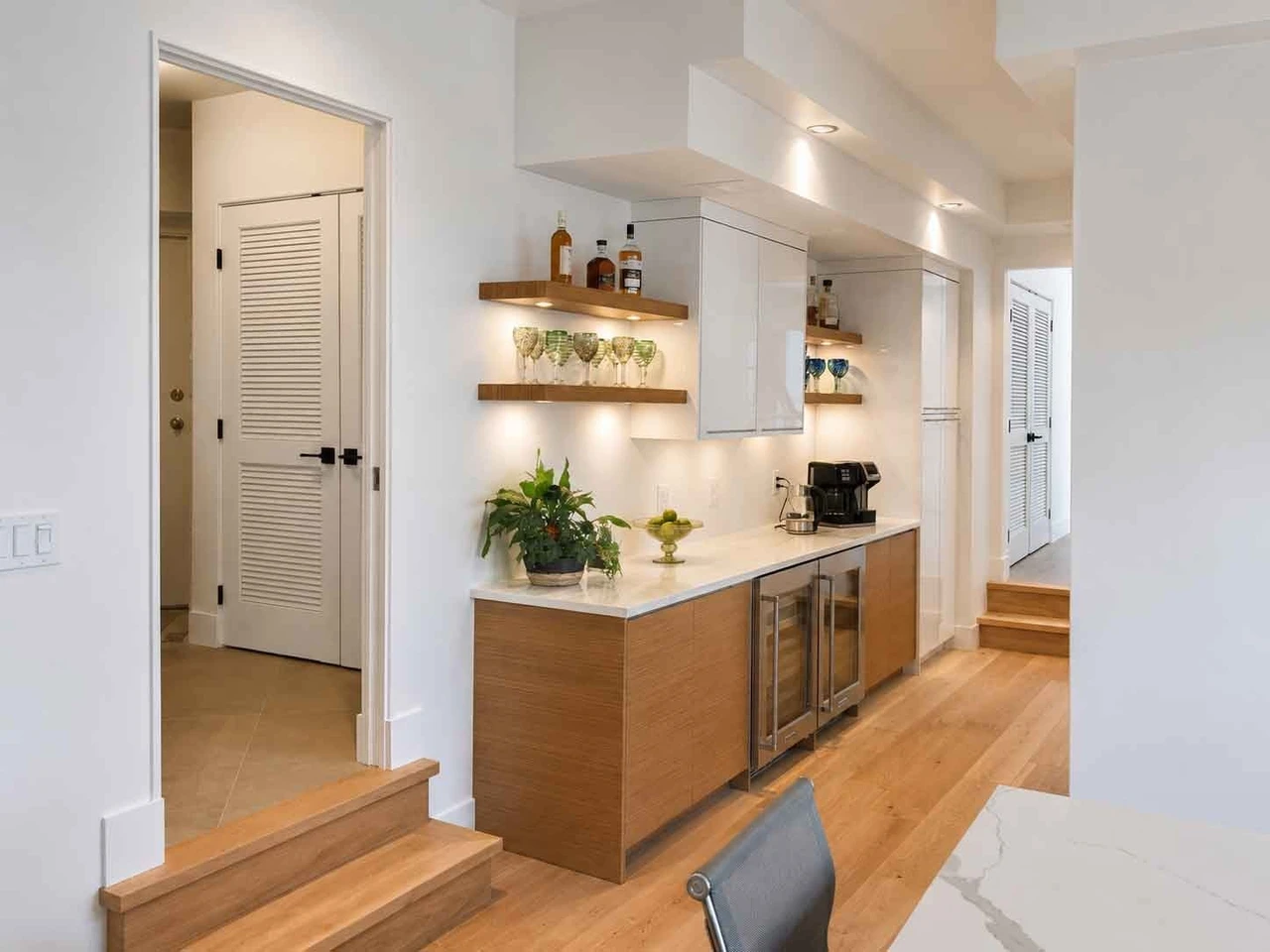 Stellar Craft Cabinetry Inc. modern kitchen cabinetry with built-in shelves and bar seating