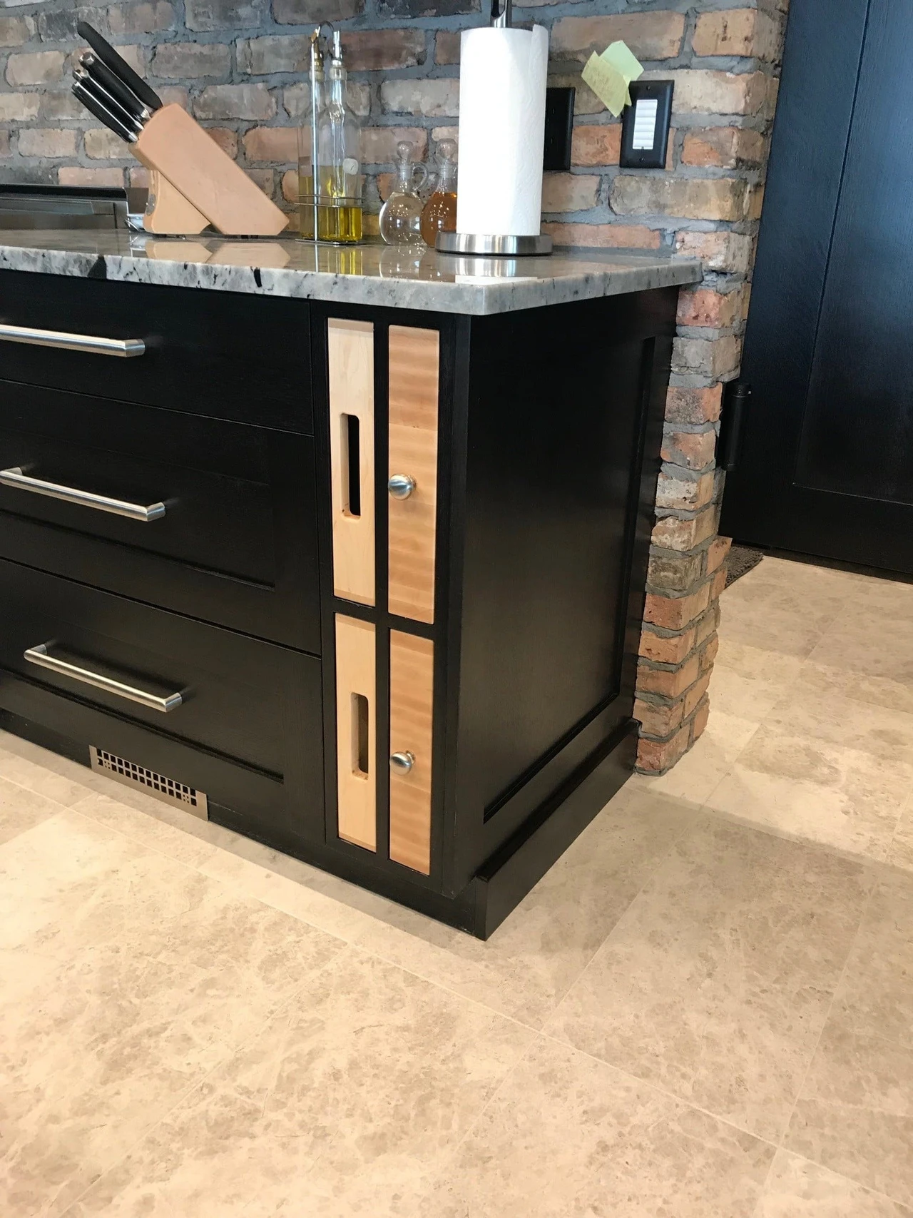 Stellar Craft Cabinetry Inc. modern black cabinet with wood-framed doors and stone countertop