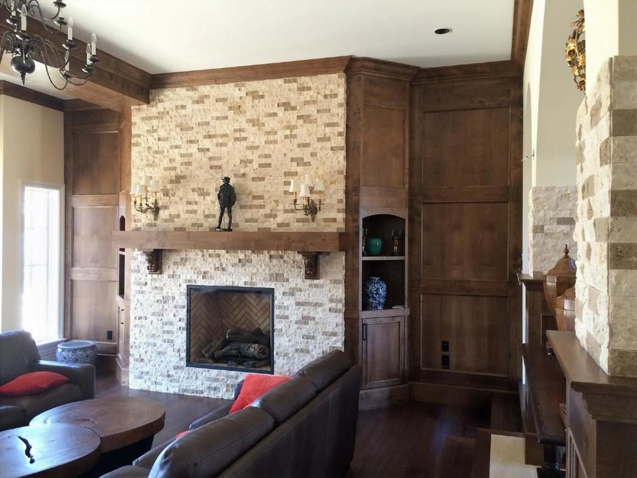 Stellar Craft Cabinetry Inc. custom cabinetry and stone fireplace surround in a living room interior