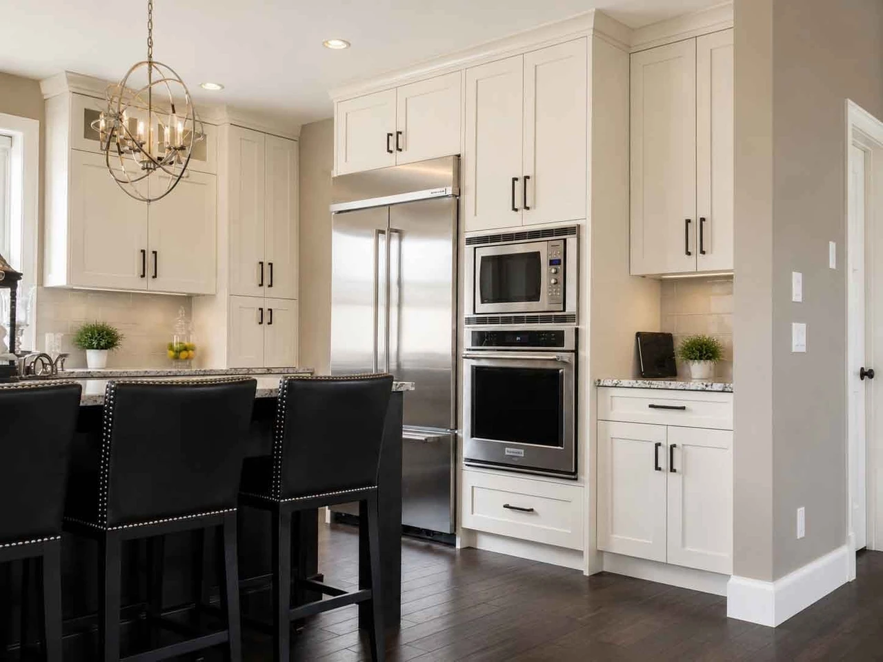 Stellar Craft Cabinetry Inc. kitchen with white shaker cabinets, built-in oven and microwave, and custom cabinetry