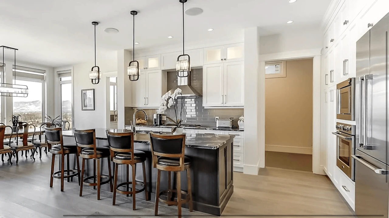 Stellar Craft Cabinetry Inc. modern white kitchen with custom cabinetry and island seating