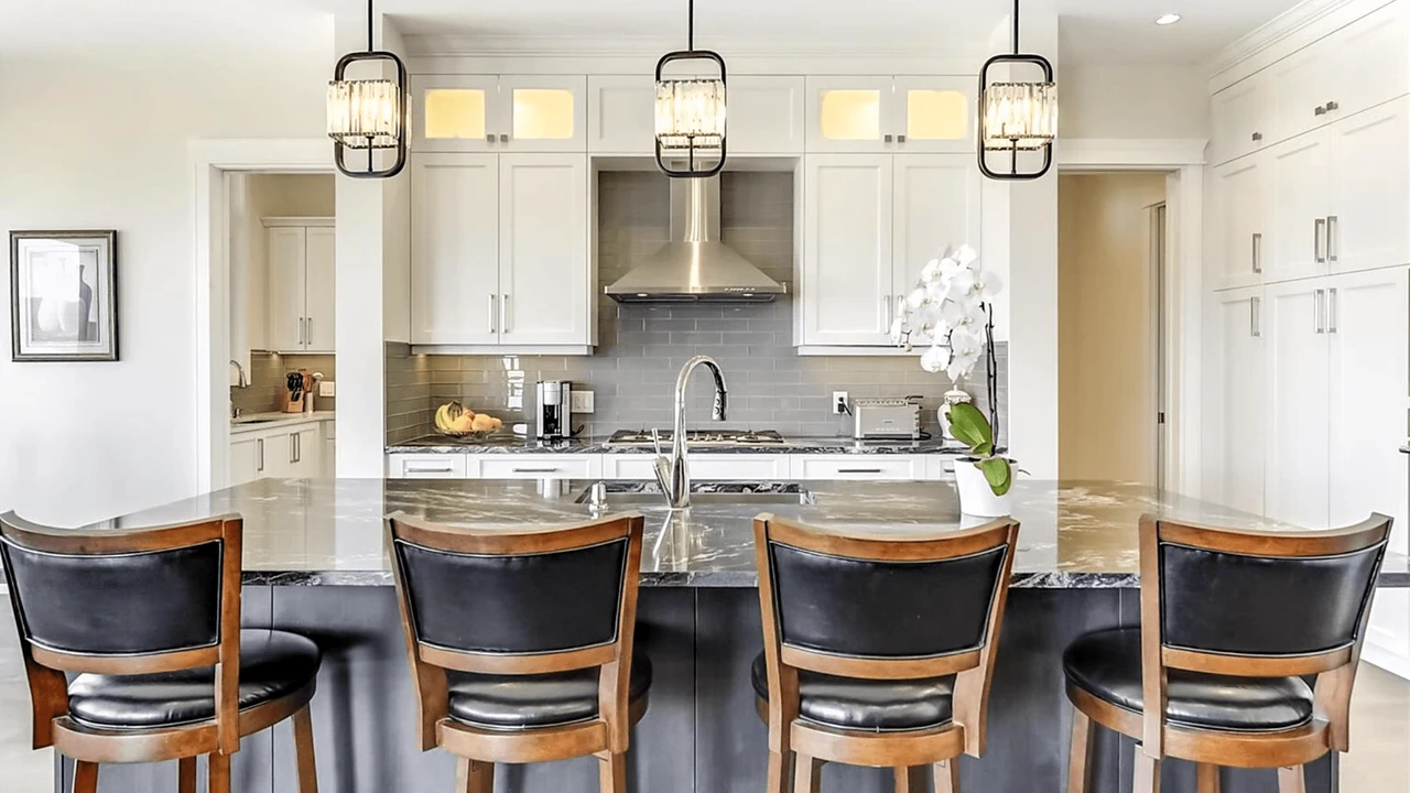 Stellar Craft Cabinetry Inc. modern white kitchen with custom cabinets, island seating, and stainless range hood