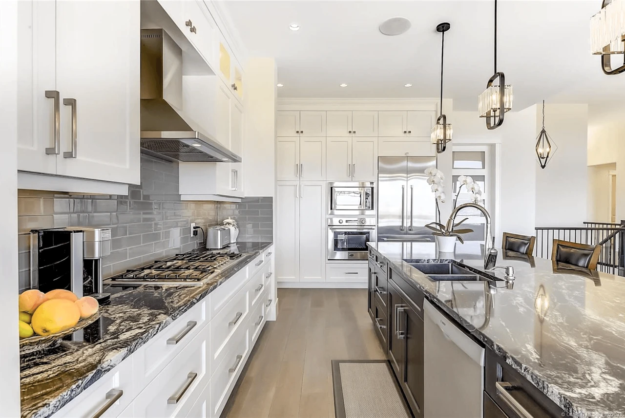 Stellar Craft Cabinetry Inc. modern white and dark kitchen with custom cabinets and quartz countertops