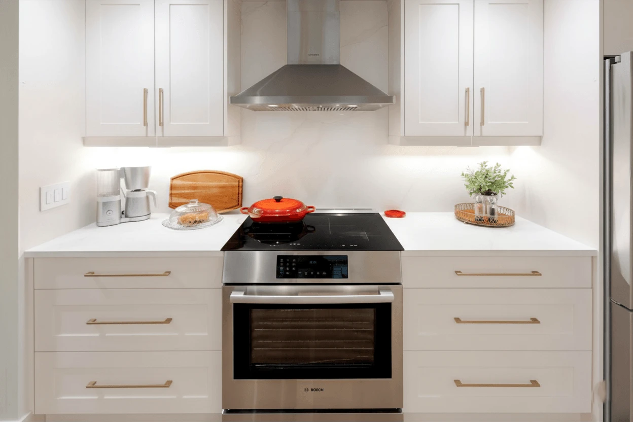 Stellar Craft Cabinetry Inc. kitchen with custom wood cabinetry, marble backsplash, and built-in shelving