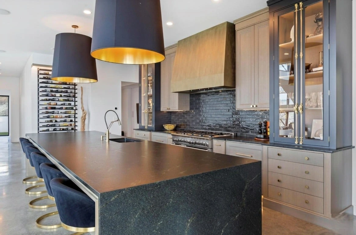 Stellar Craft Cabinetry Inc. modern kitchen with custom cabinetry, dark countertops, and glass-front cabinets