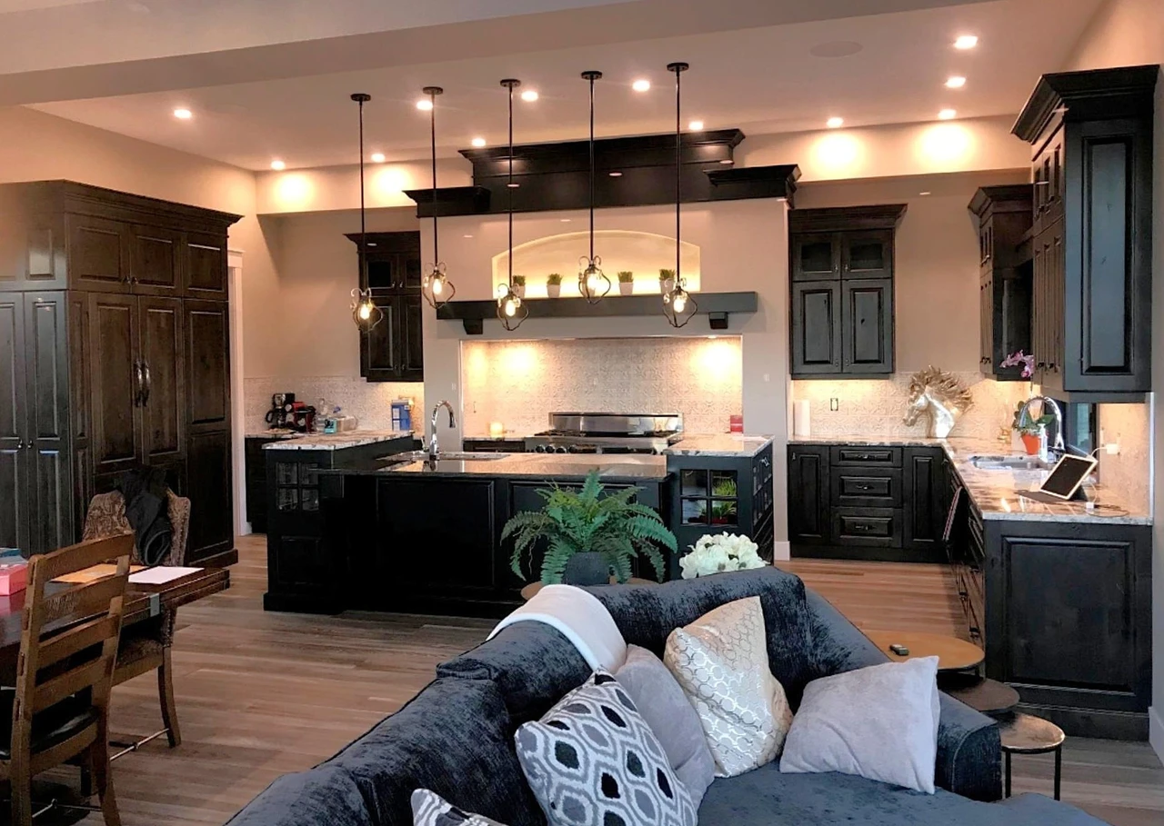 Stellar Craft Cabinetry Inc. custom dark cabinetry and kitchen island with pendant lighting