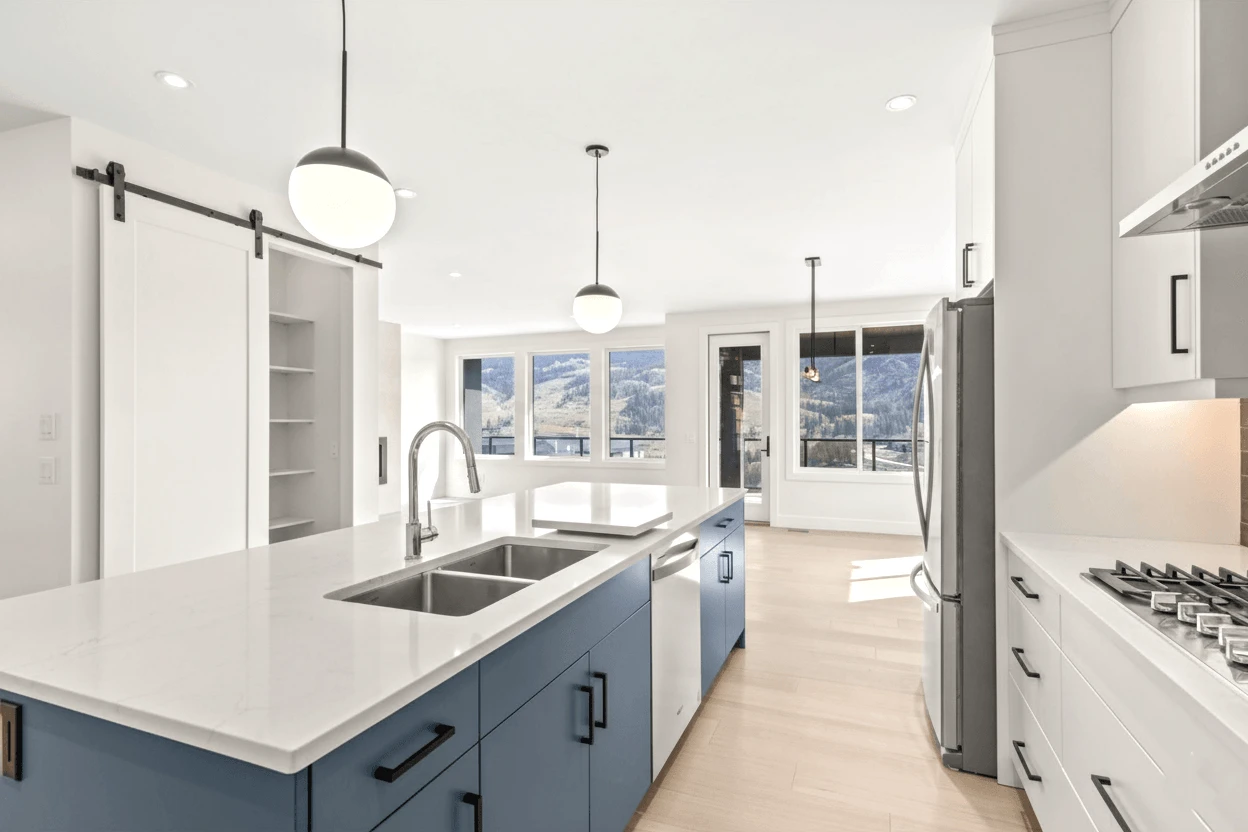Stellar Craft Cabinetry Inc. modern kitchen with custom white and blue cabinets, countertops, and stainless appliances