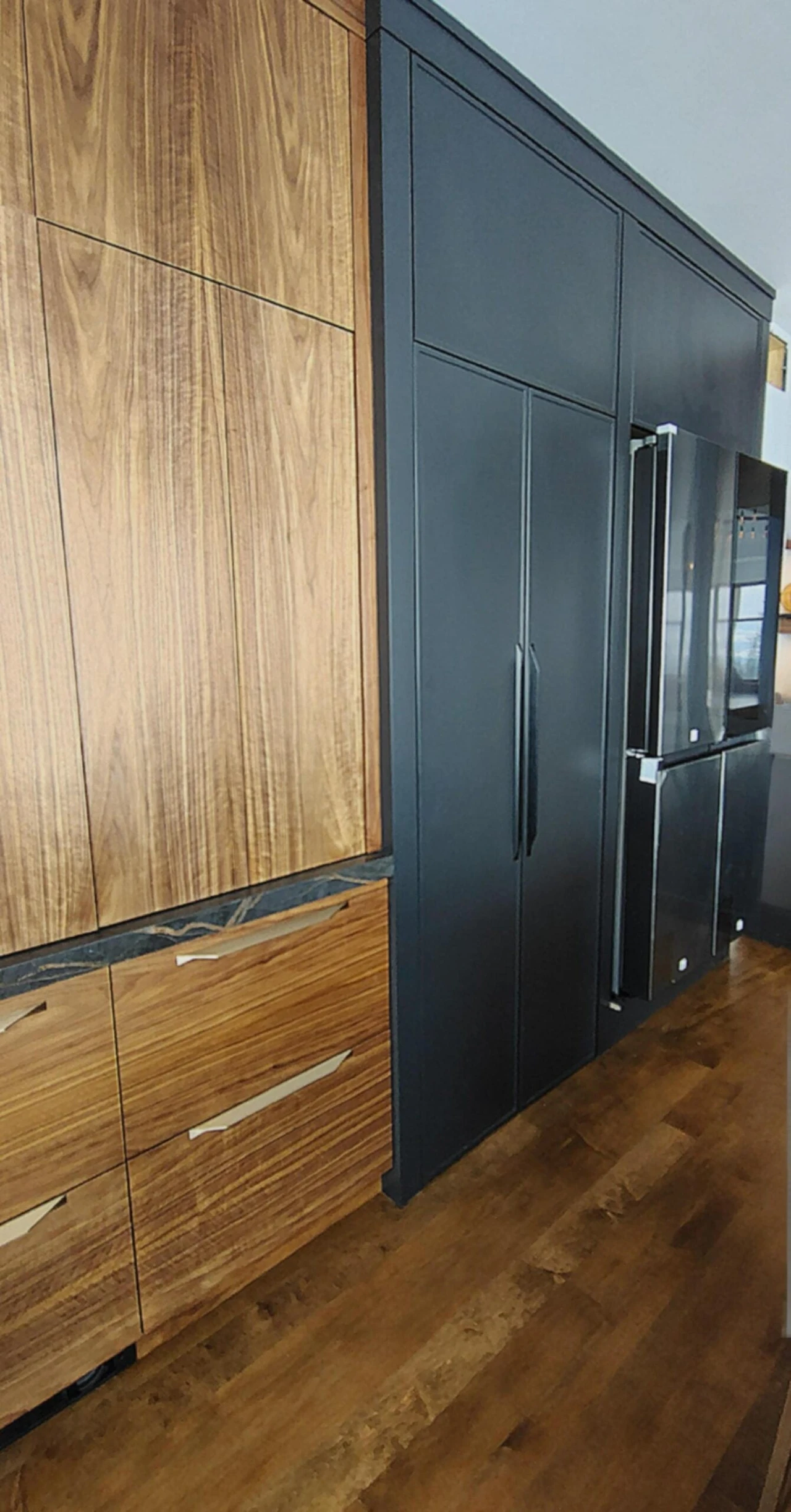 Stellar Craft Cabinetry Inc. custom kitchen cabinets with wood panel doors and dark hardware