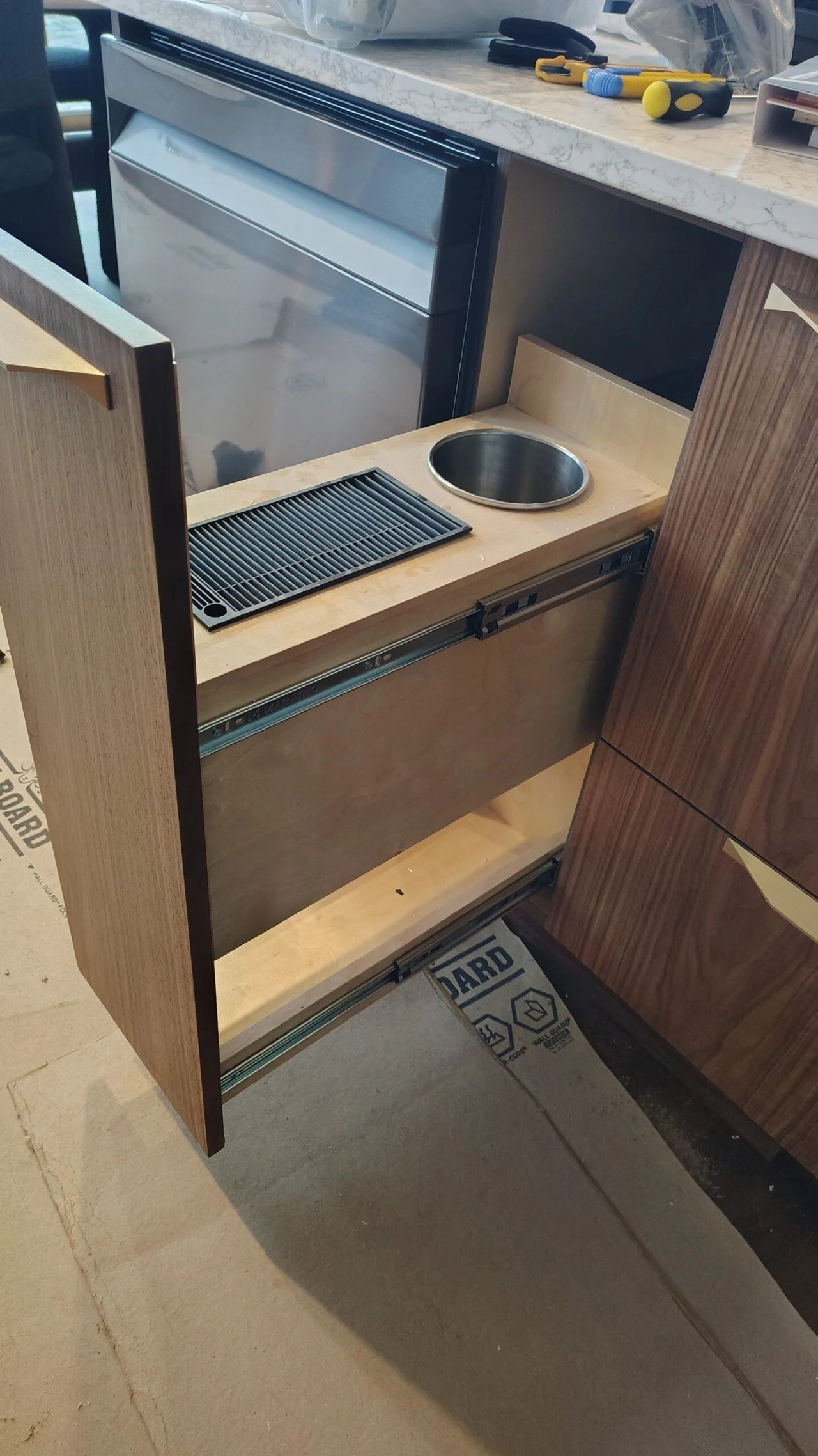 Stellar Craft Cabinetry Inc. custom cabinet base with sink cutout during installation