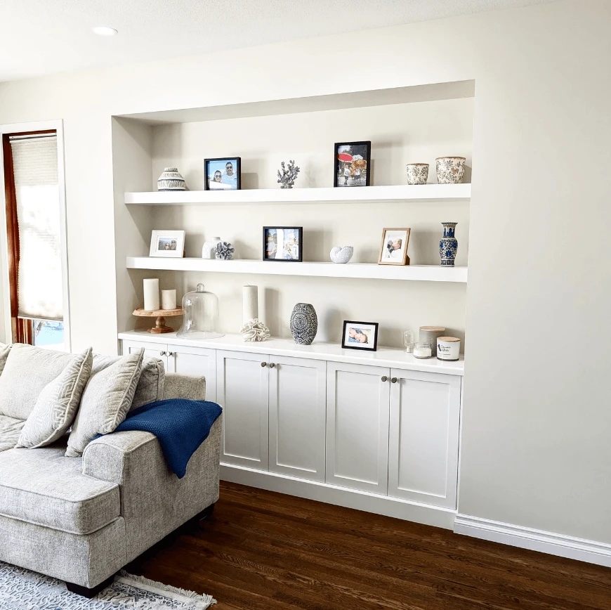 Stellar Craft Cabinetry Inc. built-in white cabinetry with open shelving display in a living room