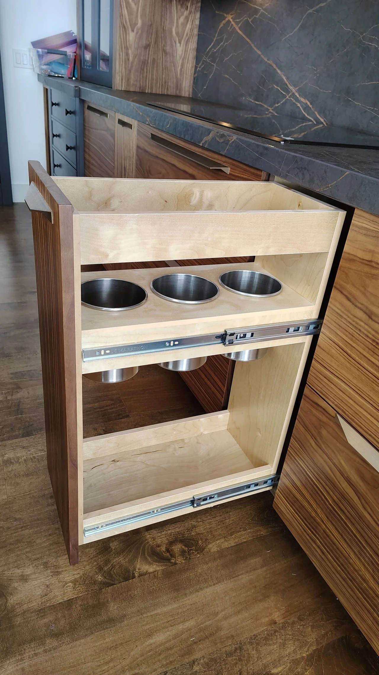 Custom cabinet vanity with built-in triple sink basins and wood cabinetry detail by Stellar Craft Cabinetry Inc.