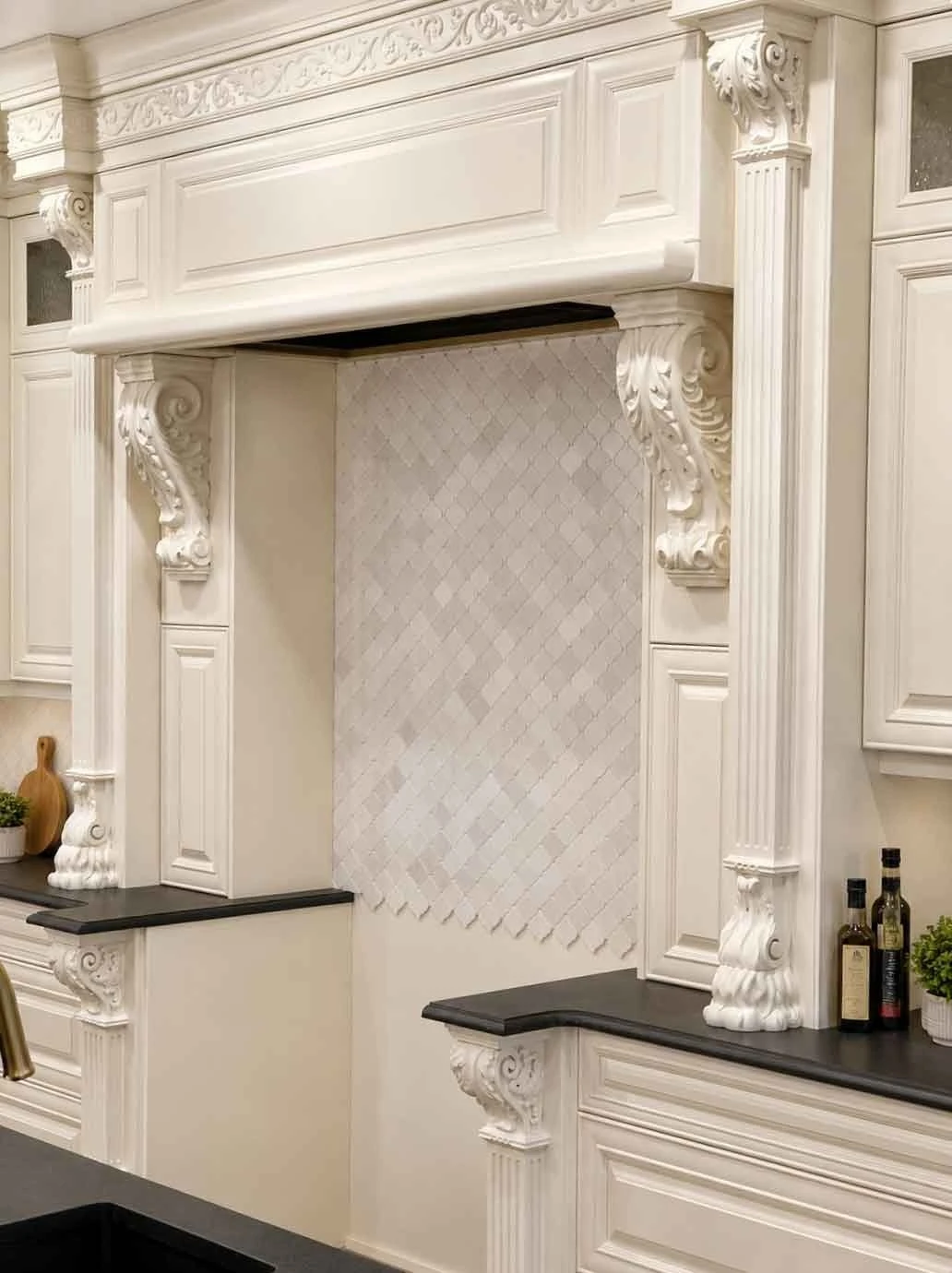 Stellar Craft Cabinetry Inc. luxury white custom cabinetry with decorative molding and stone backsplash