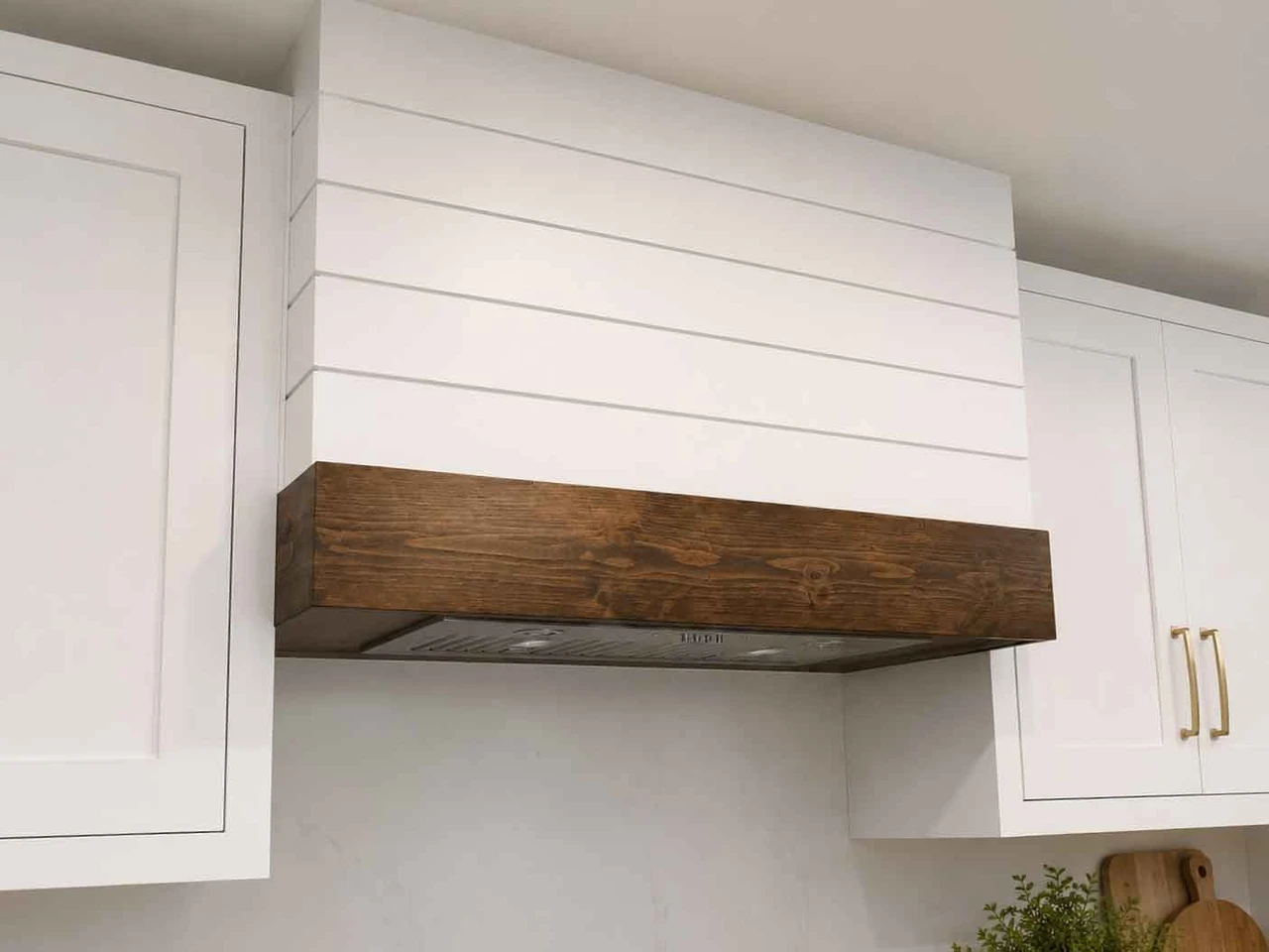 Stellar Craft Cabinetry Inc. custom wood range hood and white built-in cabinets