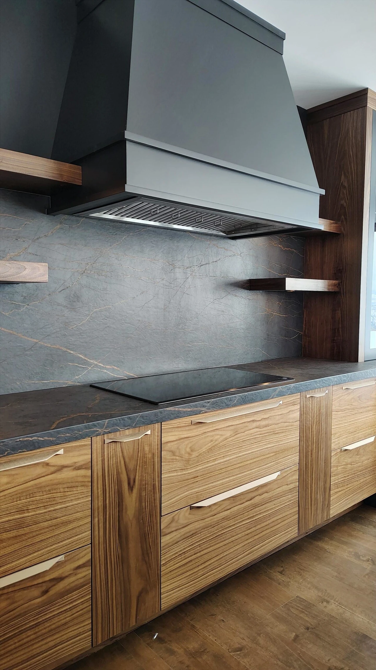 Stellar Craft Cabinetry Inc. modern kitchen cabinetry with built-in range hood and stone backsplash